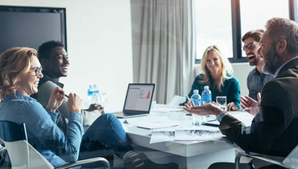 group laughing in meeting