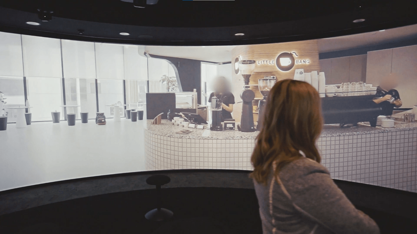A Deakin staff member standing and viewing a video in the Nyaal 360-degree theatre.