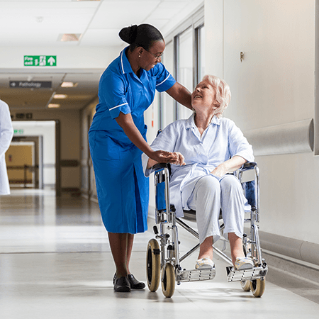 Nurse providing care for a woman in wheel chair 