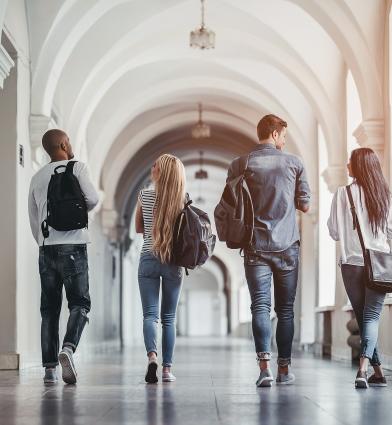 Students walking down university corridor