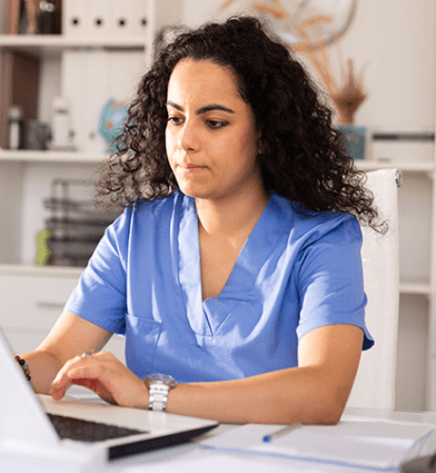 Healthcare professional working on her laptop