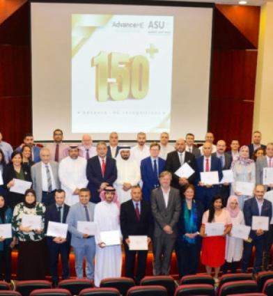 A group shot of people, some wearing Arabic clothing, holding accreditation certificates 