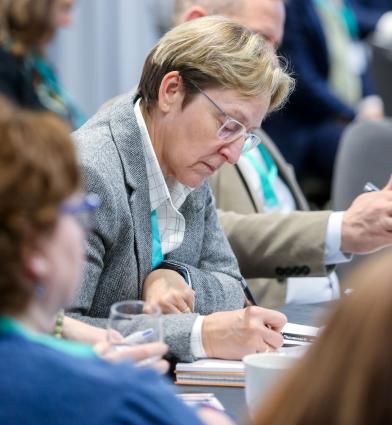 Delegates at conference making notes